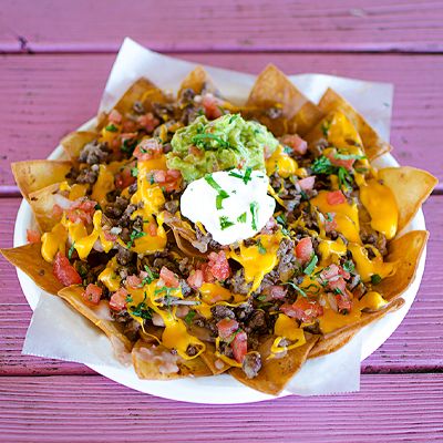 Loaded nachos with guacamole and sour cream